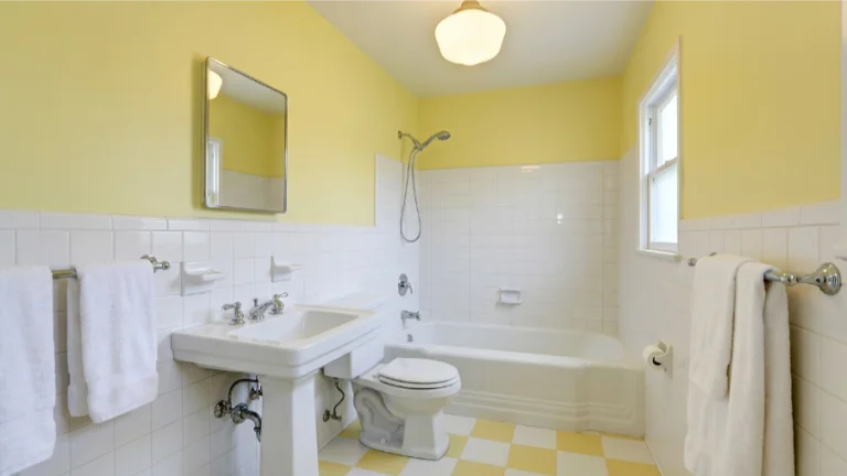 Pastel Yellow Bathroom With White Fixtures